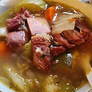 a person holding a bowl of soup