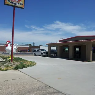 a chicken in front of a restaurant