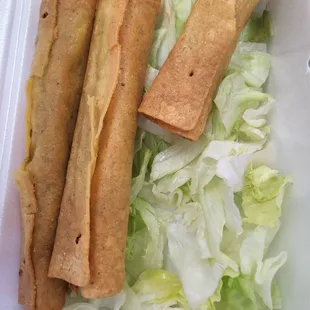 a sandwich and lettuce in a styrofoam container