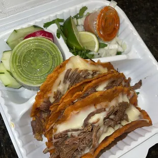 a sandwich and salad in a styrofoam container