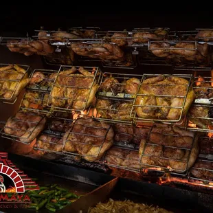 a grill full of chicken and vegetables