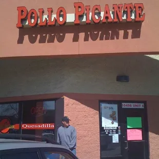 a man standing in front of a restaurant