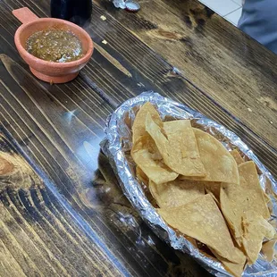 a plate of chips and a bowl of salsa