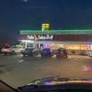 cars parked in a parking lot at night