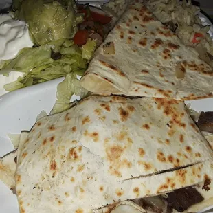 Steak quesadilla with rice, guac,air cream and salad.