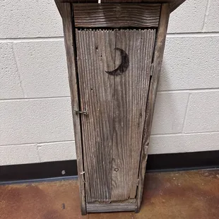 a wooden outhouse