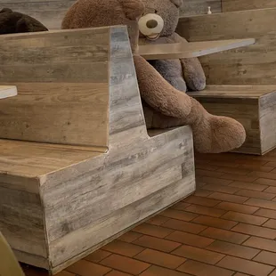 a teddy bear sitting on a bench