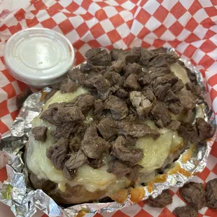Baked potato with Ribeye steak &amp; cheese.