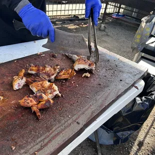 a person cutting meat