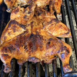 a close up of a chicken on a grill