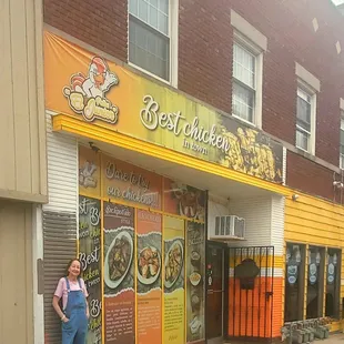 a woman standing in front of a restaurant