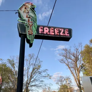 a neon sign on a pole
