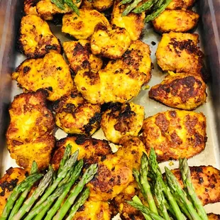 a tray of roasted cauliflower and asparagus