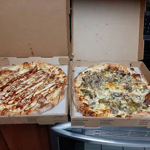two pizzas in boxes