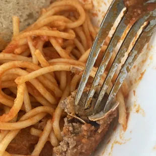 a fork in a plate of spaghetti