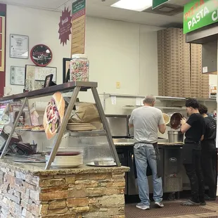 Behind look of preparation of fresh pizza