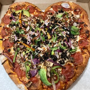 Heart shaped valentine combination pizza