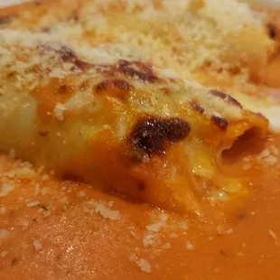 Indecisive One half manicotti, one half cannelloni topped with sugarosa sauce and mozzarella