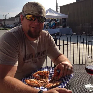 Husband with his mushroom sausage pizza! $13 for two pies is pretty good in my book!