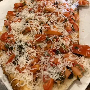 a pizza topped with tomatoes and cheese