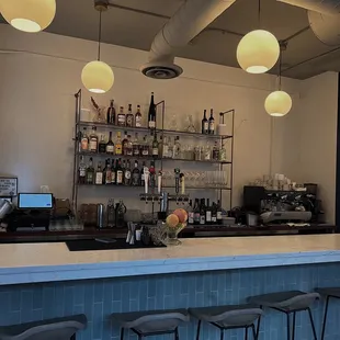 a bar with stools and shelves