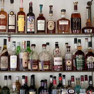 a shelf full of liquor bottles