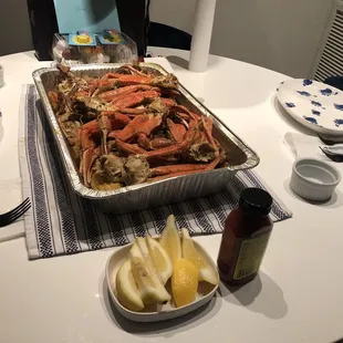 a pan of crab legs on a table