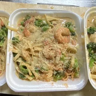 three trays of pasta and vegetables