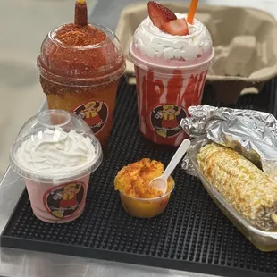 Raspado De Mango, Strawberry Cheesecake Shake, Poncho's Mangoneado Ice, and an Elote.
