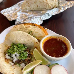 Carnitas taco (birria taco &amp; consome) Chicken burrito in back