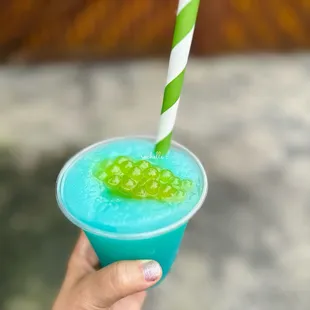 a person holding a blue drink