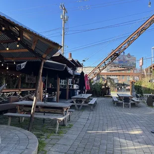 Exterior patio looking North; the covered area to the West (left) has a long cozy fireplace.