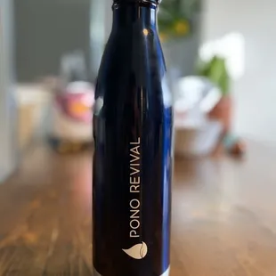 a blue water bottle on a wooden table