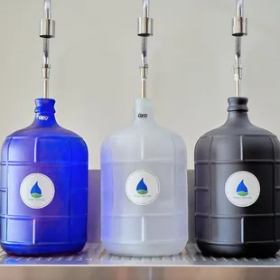 a row of blue, black, and white water bottles