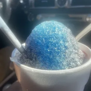 Shaved ice (tigers blood, blue raspberry, wild cherry) with soft serve vanilla ice cream in the middle. Amazing!!!!