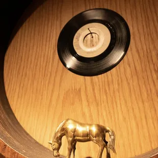 a vinyl record and a horse figurine