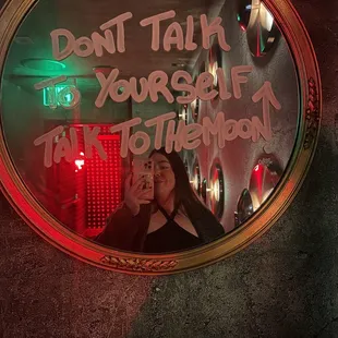 a woman taking a selfie in a mirror