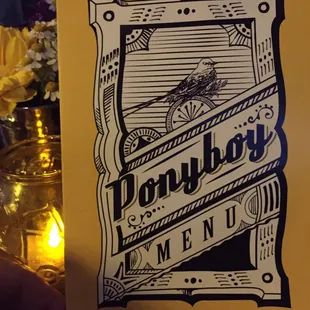 Menu cover backlit with candlelight.