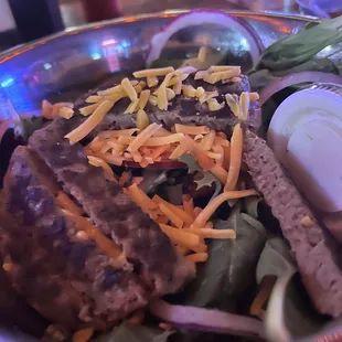 Salad with burger patty and avocado