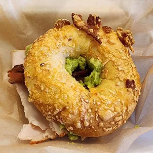Turkey, bacon, avocado sandwich on a bacon Asiago bagel