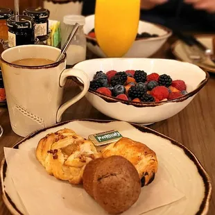 a plate of food and a glass of orange juice