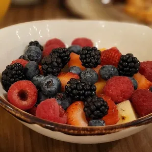 a bowl of mixed berries and bananas