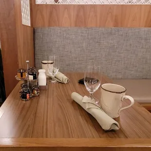 a table with a cup of coffee and a mug on it