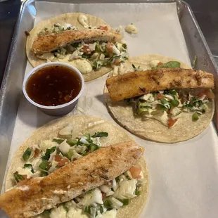 a variety of tacos on a tray