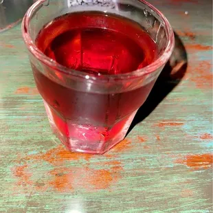 a glass of red liquid