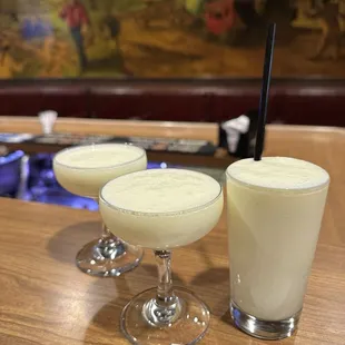 ows three cocktails on a table