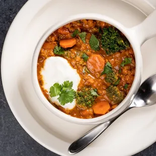 a bowl of chili and a spoon