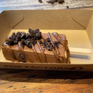  a chocolate covered donut in a box