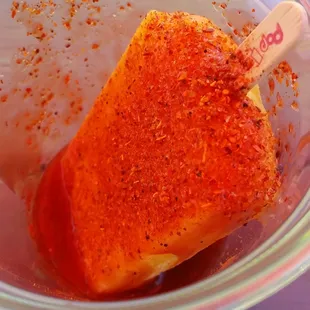 Mango paleta with spicy lime salt dip. Yumm. I was sitted under an orange tarp on a bright sunny day thats why the lighting was kinda off