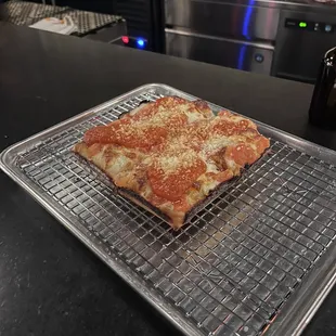 a pizza on a cooling rack